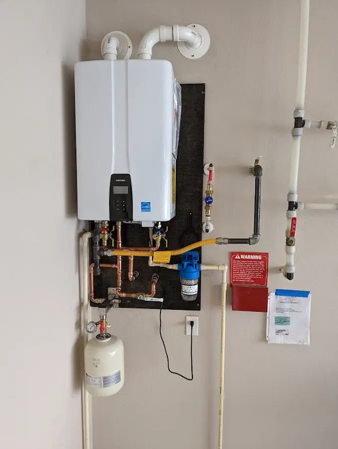 Professional plumber installing copper piping in a Daphne home